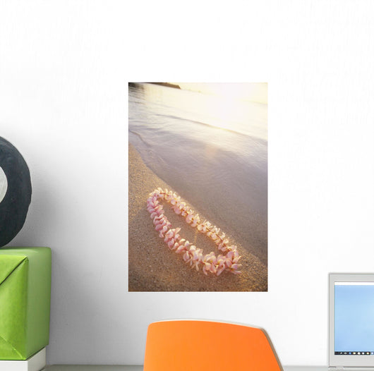 Pale Pink Plumeria Lei Along Shoreline Of Calm Water Wall Mural