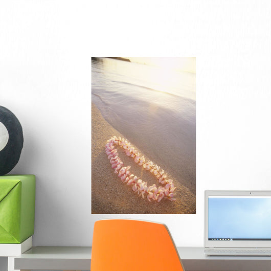 Pale Pink Plumeria Lei Along Shoreline Of Calm Water Wall Mural