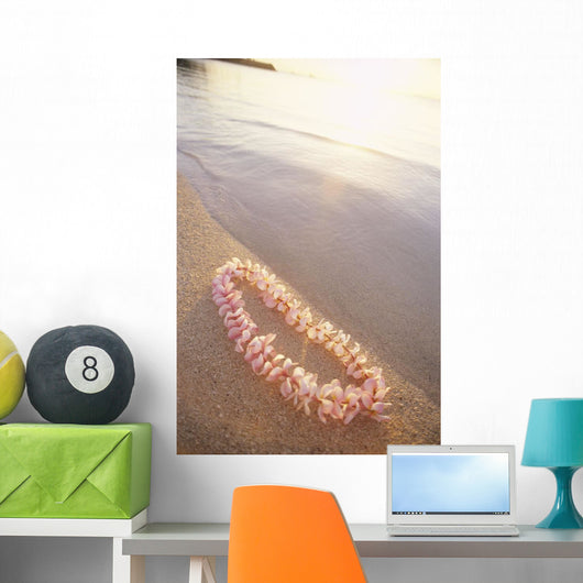 Pale Pink Plumeria Lei Along Shoreline Of Calm Water Wall Mural
