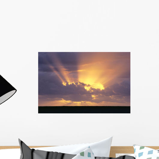 Sunrays Stream Out From Behind Clouds At Sunset, Over Dark Ocean Wall Mural