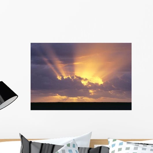 Sunrays Stream Out From Behind Clouds At Sunset, Over Dark Ocean Wall Mural