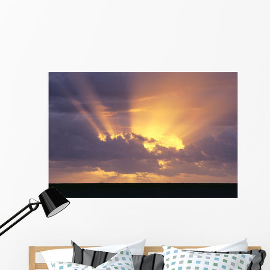 Sunrays Stream Out From Behind Clouds At Sunset, Over Dark Ocean Wall Mural