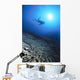 Silhouetted By Sunburst In Blue Ocean Wall Mural