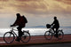 two bikers on beach and sunset Wall Mural