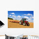 Tractor in plowed field Wall Mural