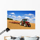 Tractor in plowed field Wall Mural