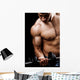 Powerful muscular man lifting weights Wall Mural