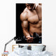 Powerful muscular man lifting weights Wall Mural