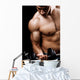 Powerful muscular man lifting weights Wall Mural