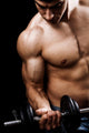 Powerful muscular man lifting weights Wall Mural