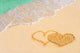 Drawing connected hearts on beach Wall Mural