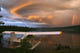 Sunlit Storm Clouds Over A Float Plane With Rainbow And Teslin Bridge Wall Mural