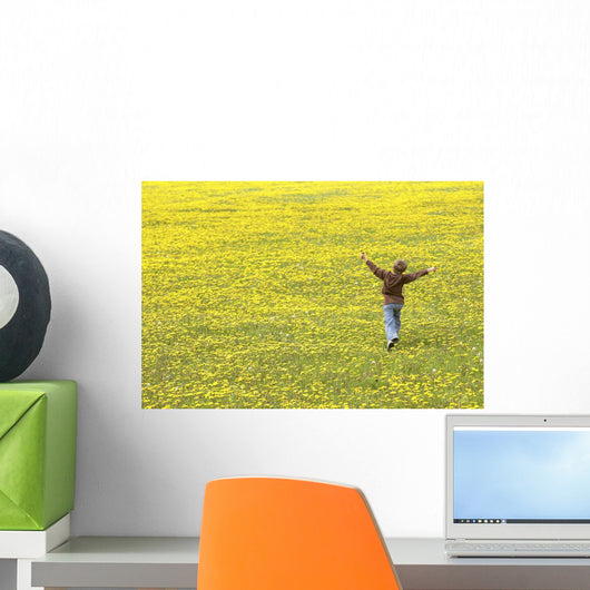 Young Boy Running Through Field Of Dandelions With Hands Up In The Air Wall Mural