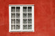 Red Timber House And Window Frame In The Old Town Wall Mural