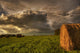 Rolled Hay Bales Under Storm Clouds On A Farm North Of Edmonton Wall Mural