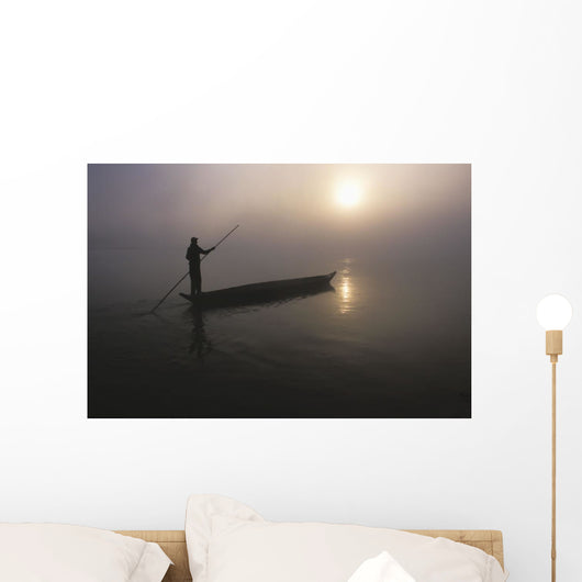 A Man Pushes His Dugout Canoe Along The Rapti River Wall Mural