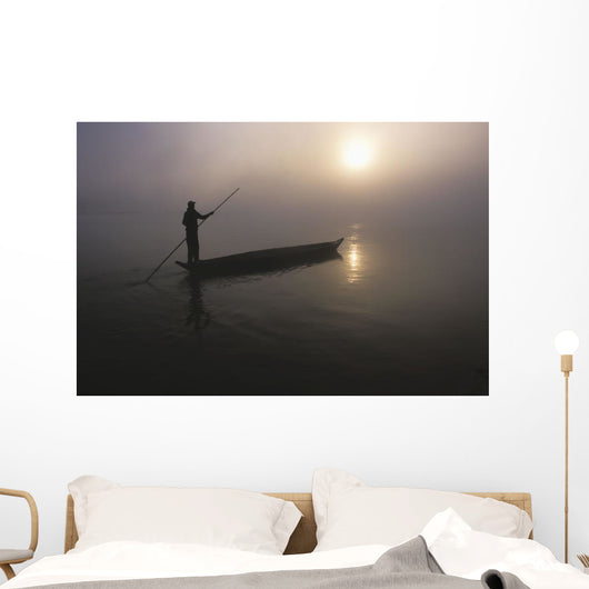 A Man Pushes His Dugout Canoe Along The Rapti River Wall Mural