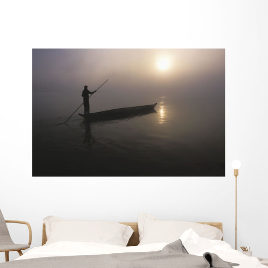 A Man Pushes His Dugout Canoe Along The Rapti River Wall Mural