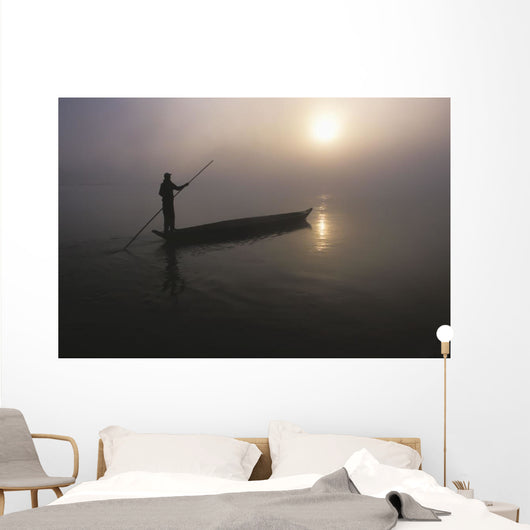 A Man Pushes His Dugout Canoe Along The Rapti River Wall Mural