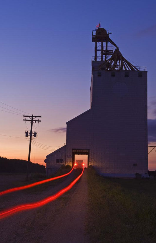 Streak Of Truck Lights And An Old Grain Elevator, Virden, Manitoba Wall Mural