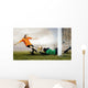 Shoot of football player and jump of goalkeeper on the field of Wall Mural