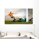 Shoot of football player and jump of goalkeeper on the field of Wall Mural