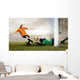 Shoot of football player and jump of goalkeeper on the field of Wall Mural
