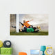 Shoot of football player and jump of goalkeeper on the field of Wall Mural