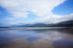 Clouds Reflected On The Wet Sand Of Inch Beach In Dingle Wall Mural
