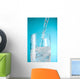 Stream Of Water Being Poured Into A Clear Glass Wall Mural