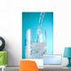 Stream Of Water Being Poured Into A Clear Glass Wall Mural