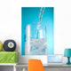 Stream Of Water Being Poured Into A Clear Glass Wall Mural