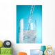 Stream Of Water Being Poured Into A Clear Glass Wall Mural
