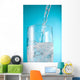 Stream Of Water Being Poured Into A Clear Glass Wall Mural