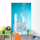 Stream Of Water Being Poured Into A Clear Glass Wall Mural
