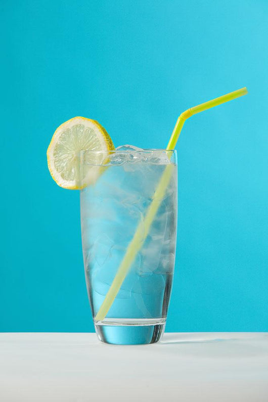 Clear Glass Of Water With Lemon And Drinking Straw Wall Mural