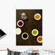 Teapot And Different Types Of Tea In Cups On A Wood Table Wall Mural