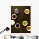 Teapot And Different Types Of Tea In Cups On A Wood Table Wall Mural