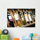 Closeup shot of wineshelf. Bottles lay over straw. Wall Mural