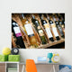 Closeup shot of wineshelf. Bottles lay over straw. Wall Mural