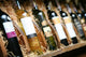 Closeup shot of wineshelf. Bottles lay over straw. Wall Mural