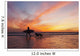 A Surfer Walks In Shallow Water With Her Dog At Sunset Wall Mural