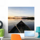 A Boat And Paddle On A Tranquil Lake At Sunset Wall Mural