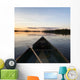 A Boat And Paddle On A Tranquil Lake At Sunset Wall Mural