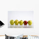 Four Yellow Apples With One Red Apple In A Row On A Reflective Surface Wall Mural