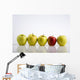 Four Yellow Apples With One Red Apple In A Row On A Reflective Surface Wall Mural