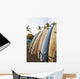 Surfboards Standing Up Against A Rack On The Beach Wall Mural