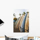 Surfboards Standing Up Against A Rack On The Beach Wall Mural