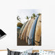 Surfboards Standing Up Against A Rack On The Beach Wall Mural