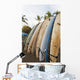 Surfboards Standing Up Against A Rack On The Beach Wall Mural
